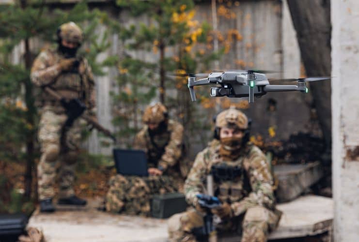 Group of armed soldiers operating a UAS in an urban environment