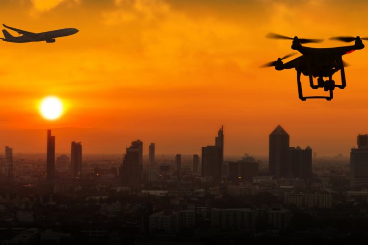 Aircraft approaching a busy city at sunset as a drone approaches, breaching established laws