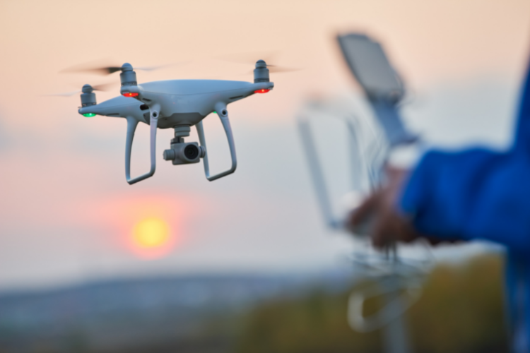 Person flying a drone with a controller. Radio frequency analysers can intercept signals between the to detect drone activity