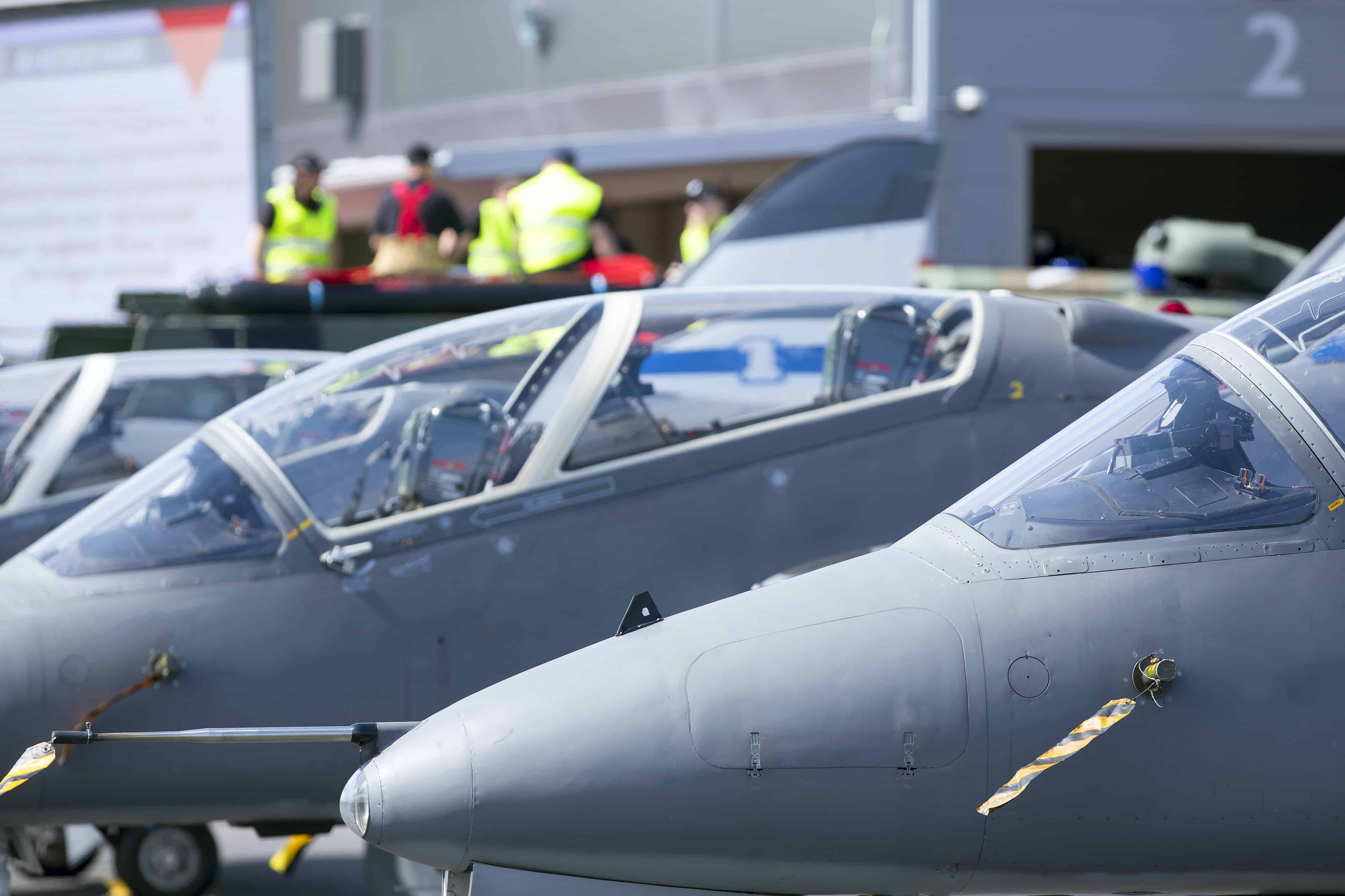 A line of fighter jets at a military air base