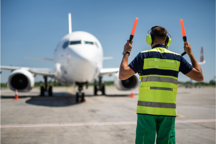man directing plane to land